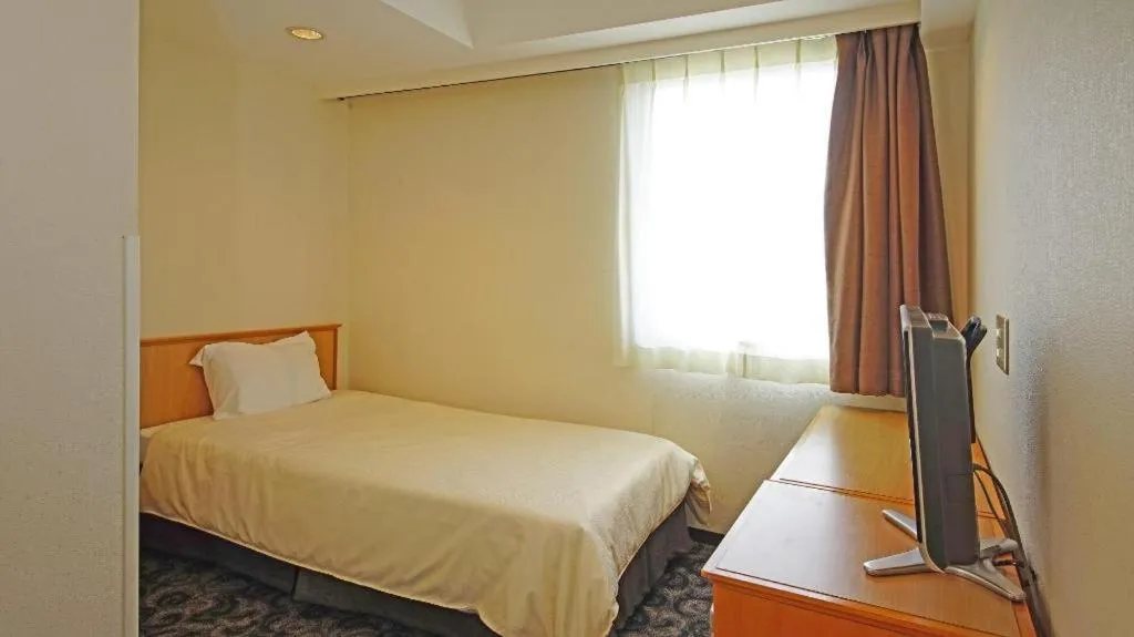 Bed in Nansei Kanko Hotel