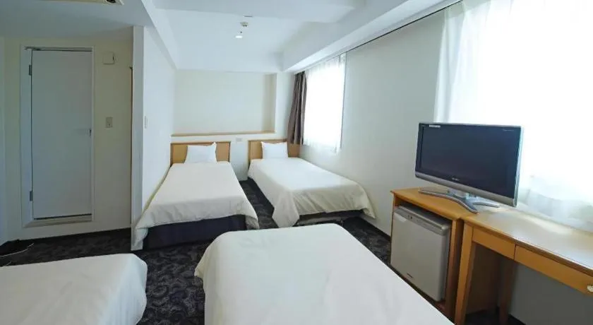 Bed in Nansei Kanko Hotel