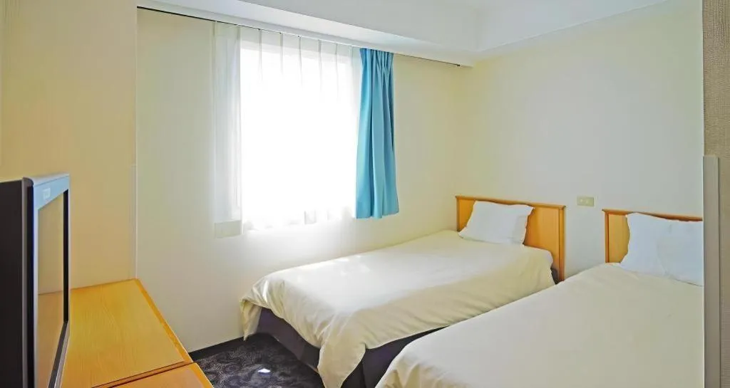 Bed in Nansei Kanko Hotel