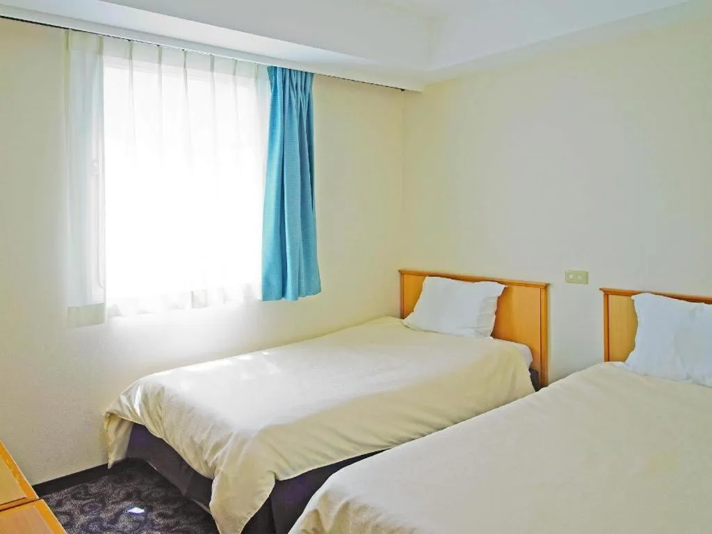 Bed in Nansei Kanko Hotel