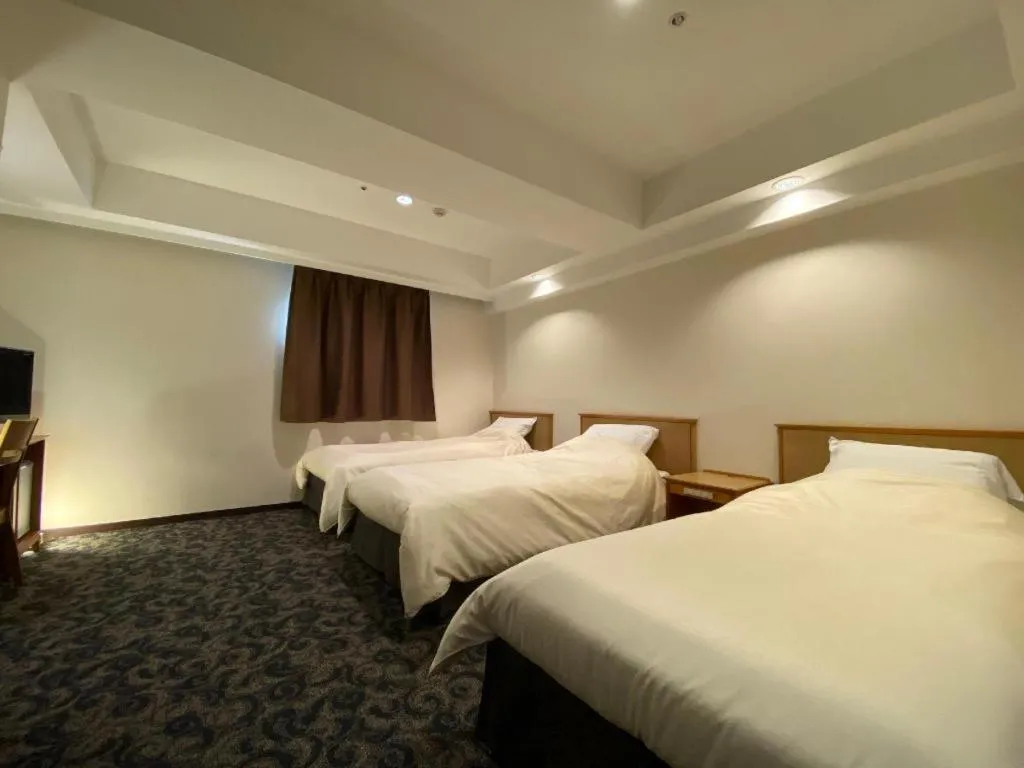 Bed in Nansei Kanko Hotel