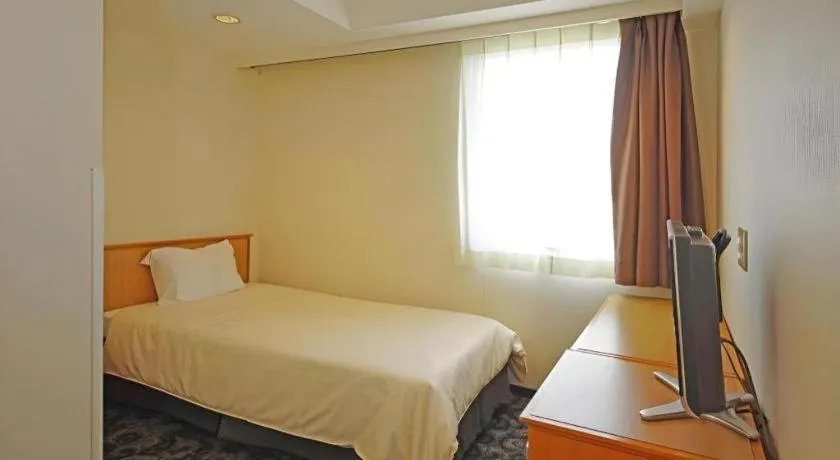 Bed in Nansei Kanko Hotel