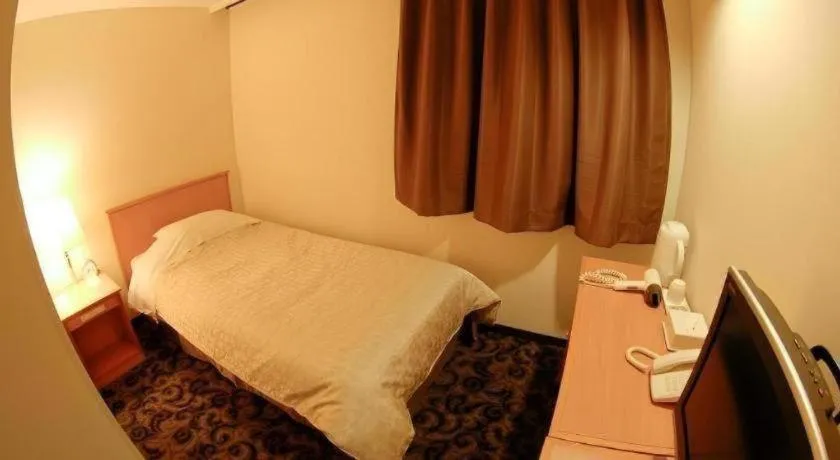 Bed in Nansei Kanko Hotel