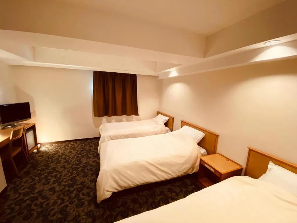 Bed in Nansei Kanko Hotel