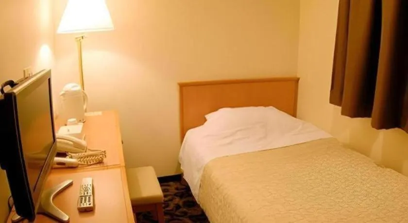 Bed in Nansei Kanko Hotel