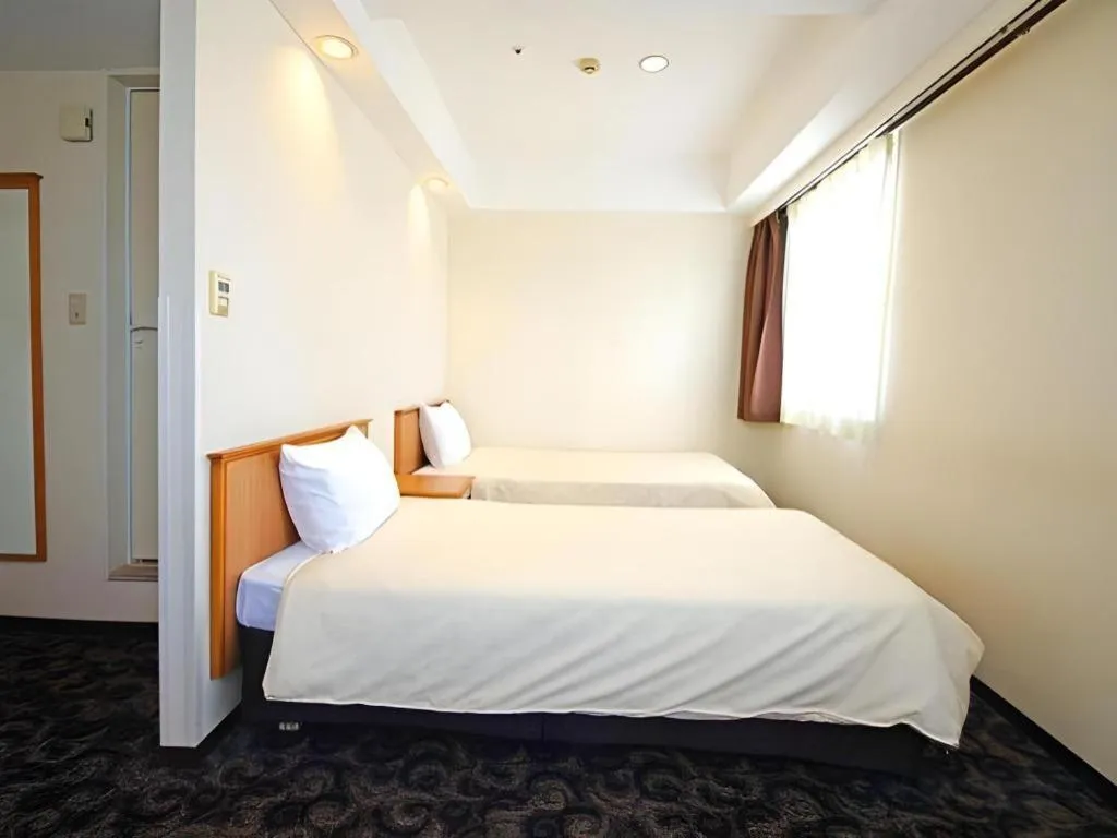 Bed in Nansei Kanko Hotel