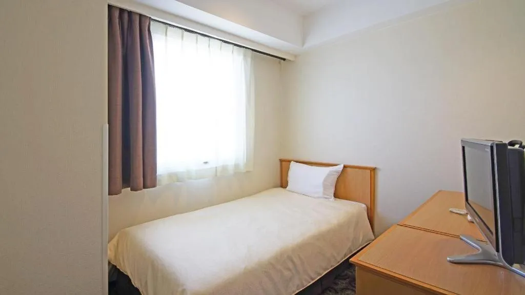 Bed in Nansei Kanko Hotel