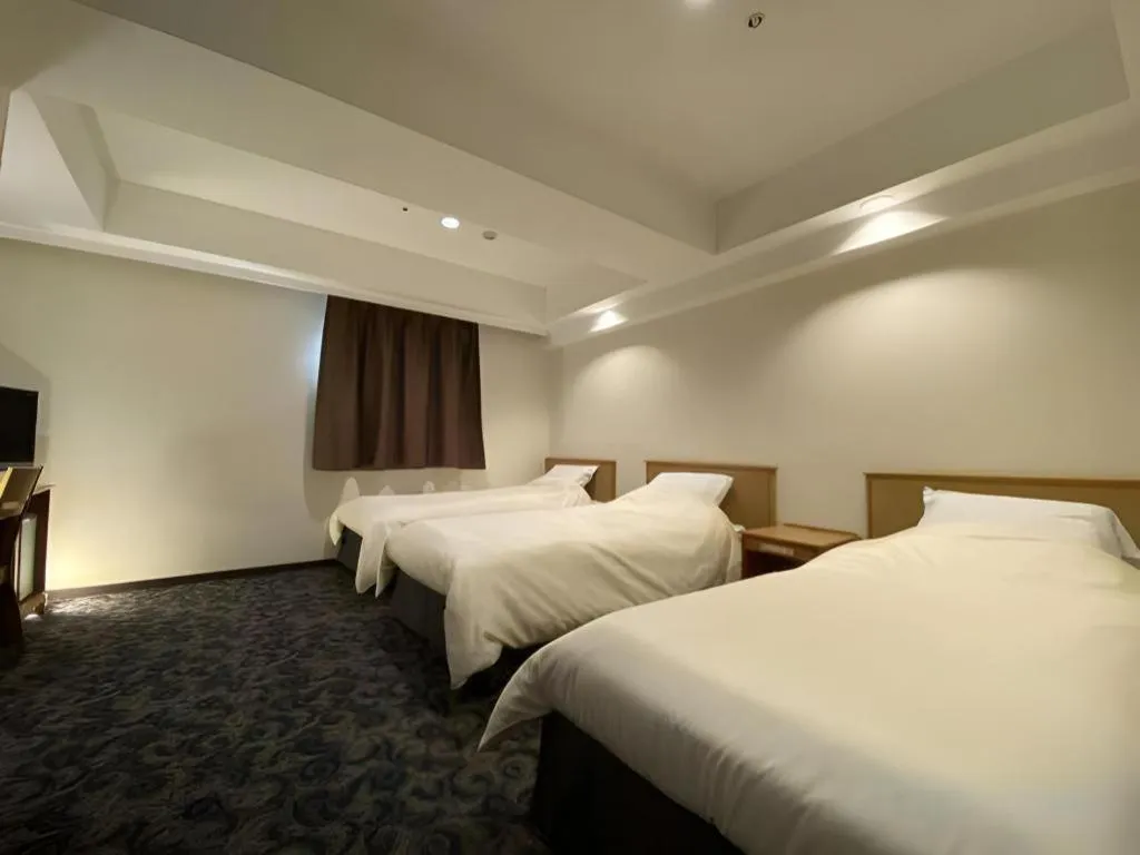 Bed in Nansei Kanko Hotel