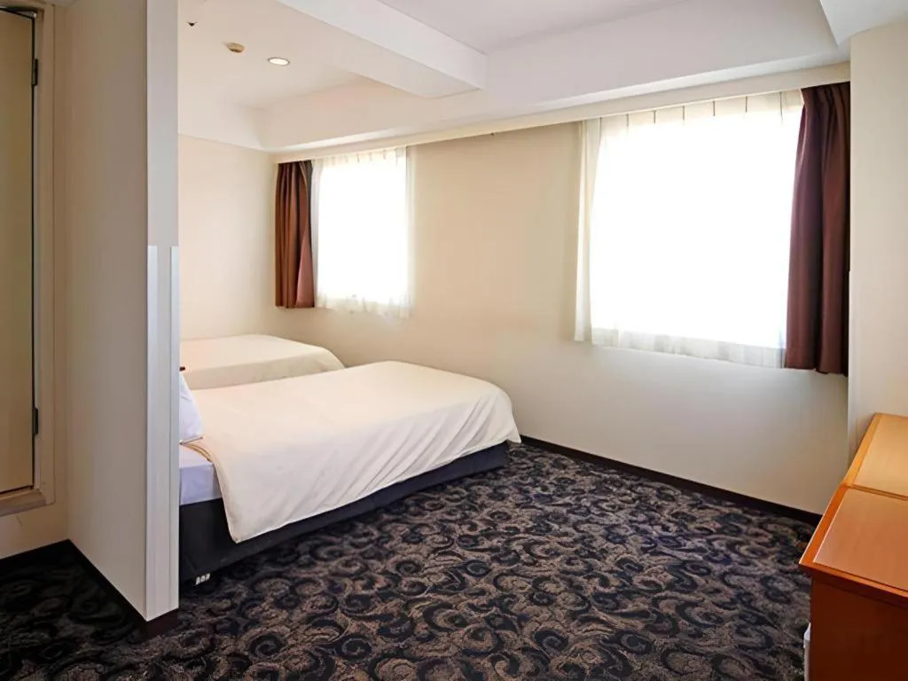 Bed in Nansei Kanko Hotel