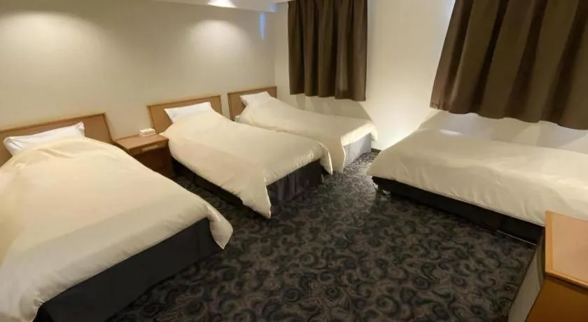 Bed in Nansei Kanko Hotel