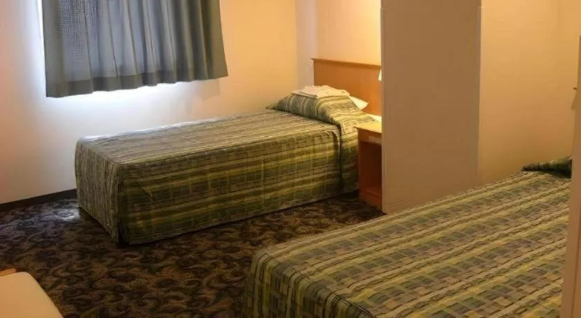 Bed in Nansei Kanko Hotel