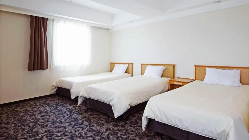 Bed in Nansei Kanko Hotel