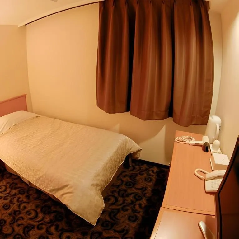 Bed in Nansei Kanko Hotel