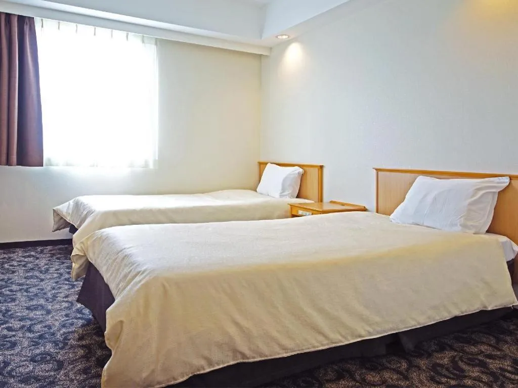 Bed in Nansei Kanko Hotel