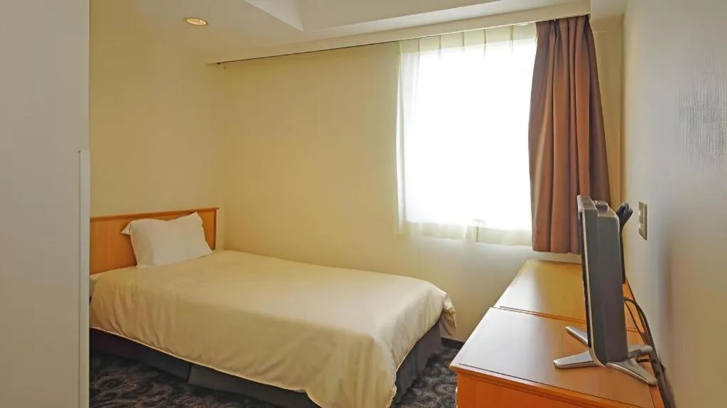 Bed in Nansei Kanko Hotel