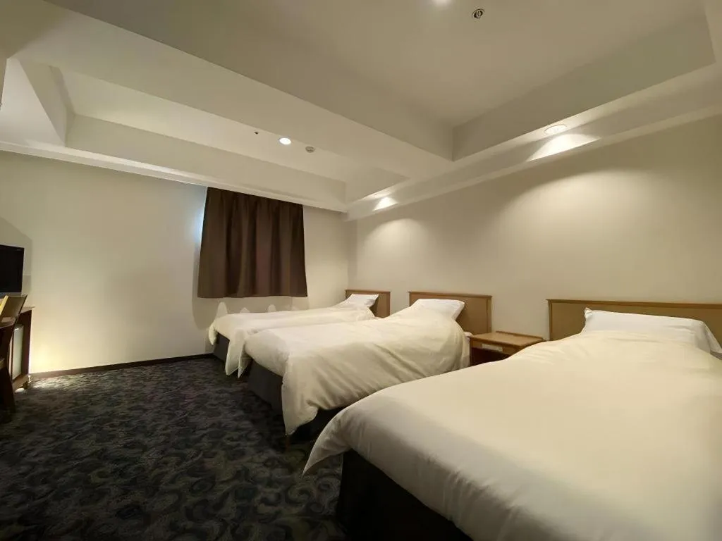 Bed in Nansei Kanko Hotel