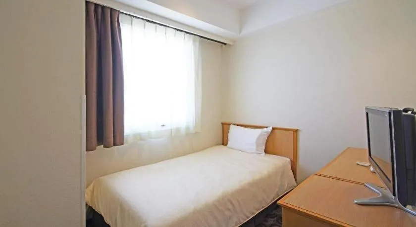 Bed in Nansei Kanko Hotel