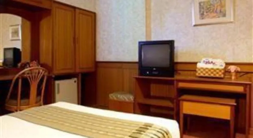 Bed in Sakol Grand Palace Hotel