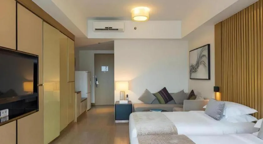 Bed in Huafa Executive Apartment Hotel Zhuhai