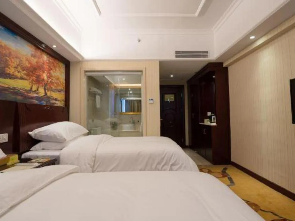 Bed in Vienna Hotel Shenzhen Pinghu Shuangyong Street Metro Station