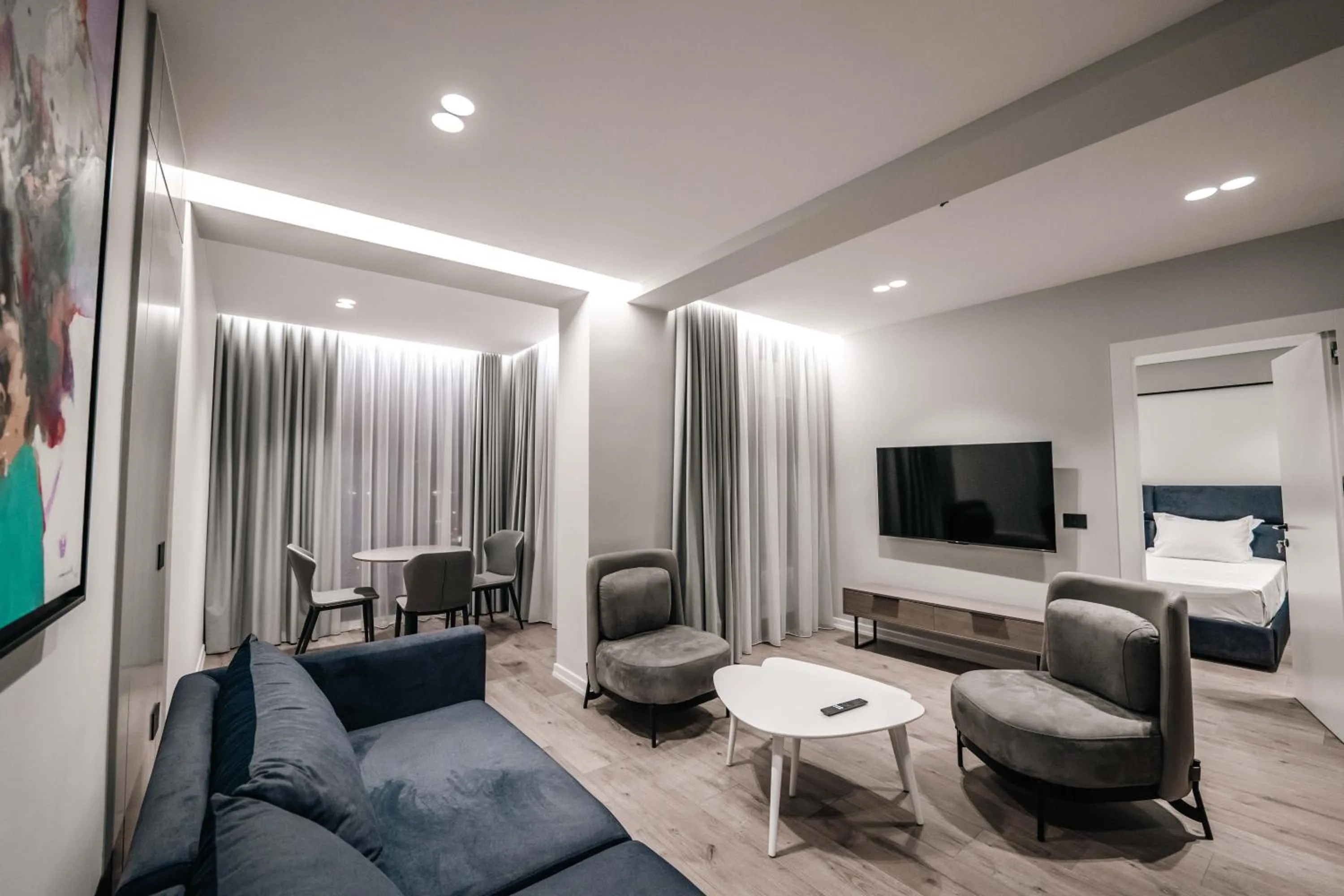 Communal lounge/ TV room, Bed in Boe Luxury Hotel