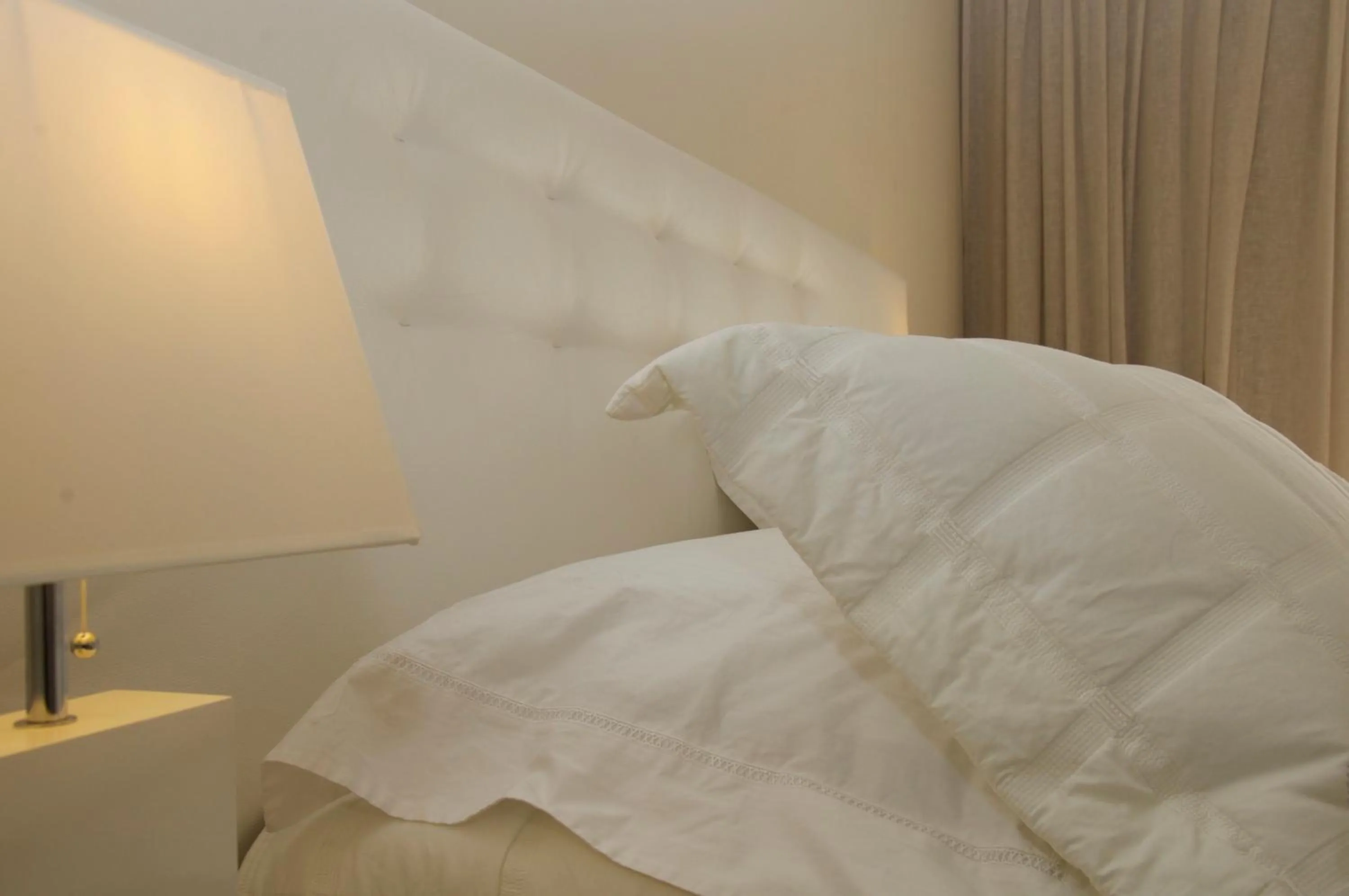 Bed in Ino Hotel & Suites