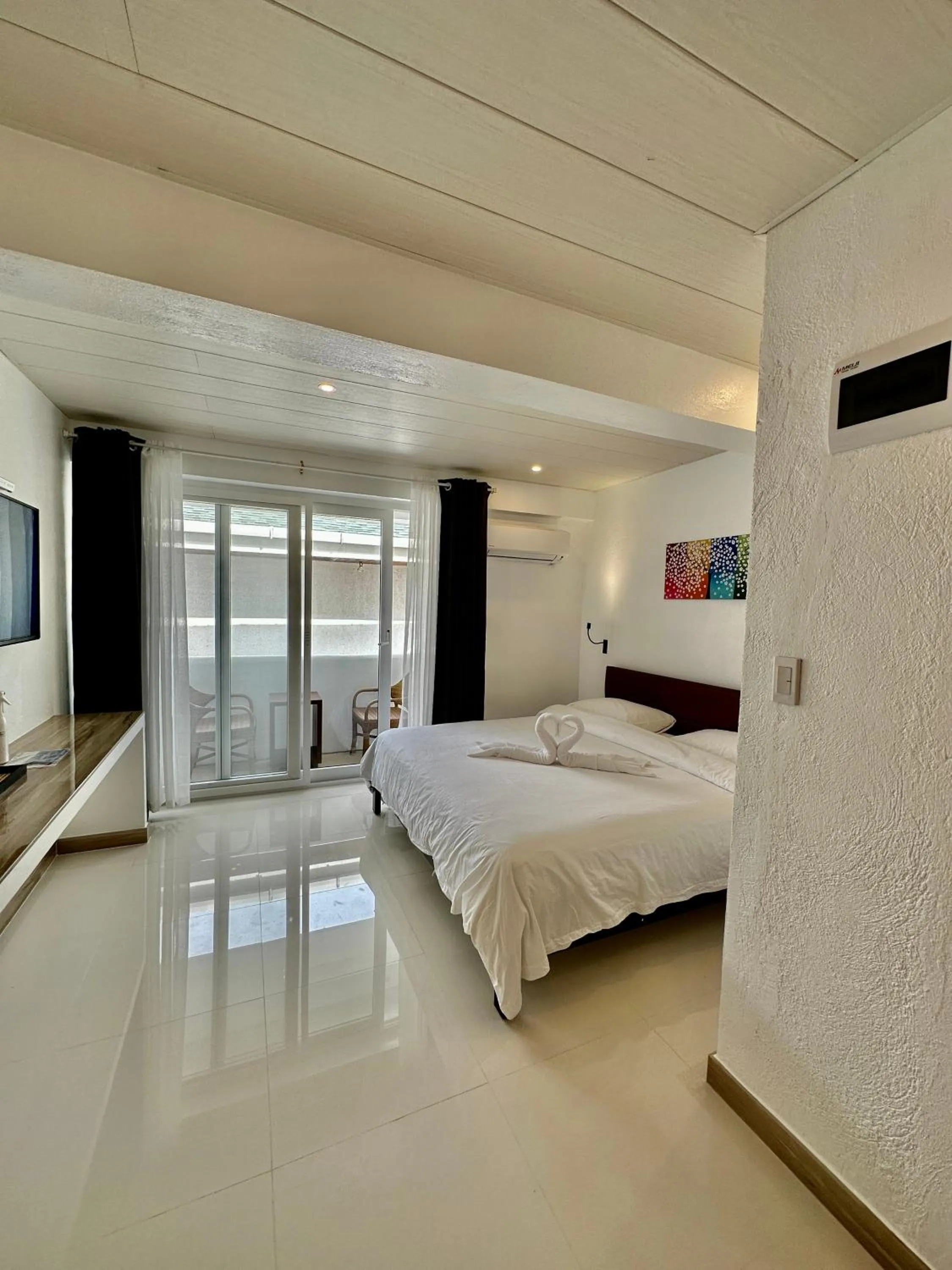 Photo of the whole room, Bed in Calypso Beach and Dive Resort