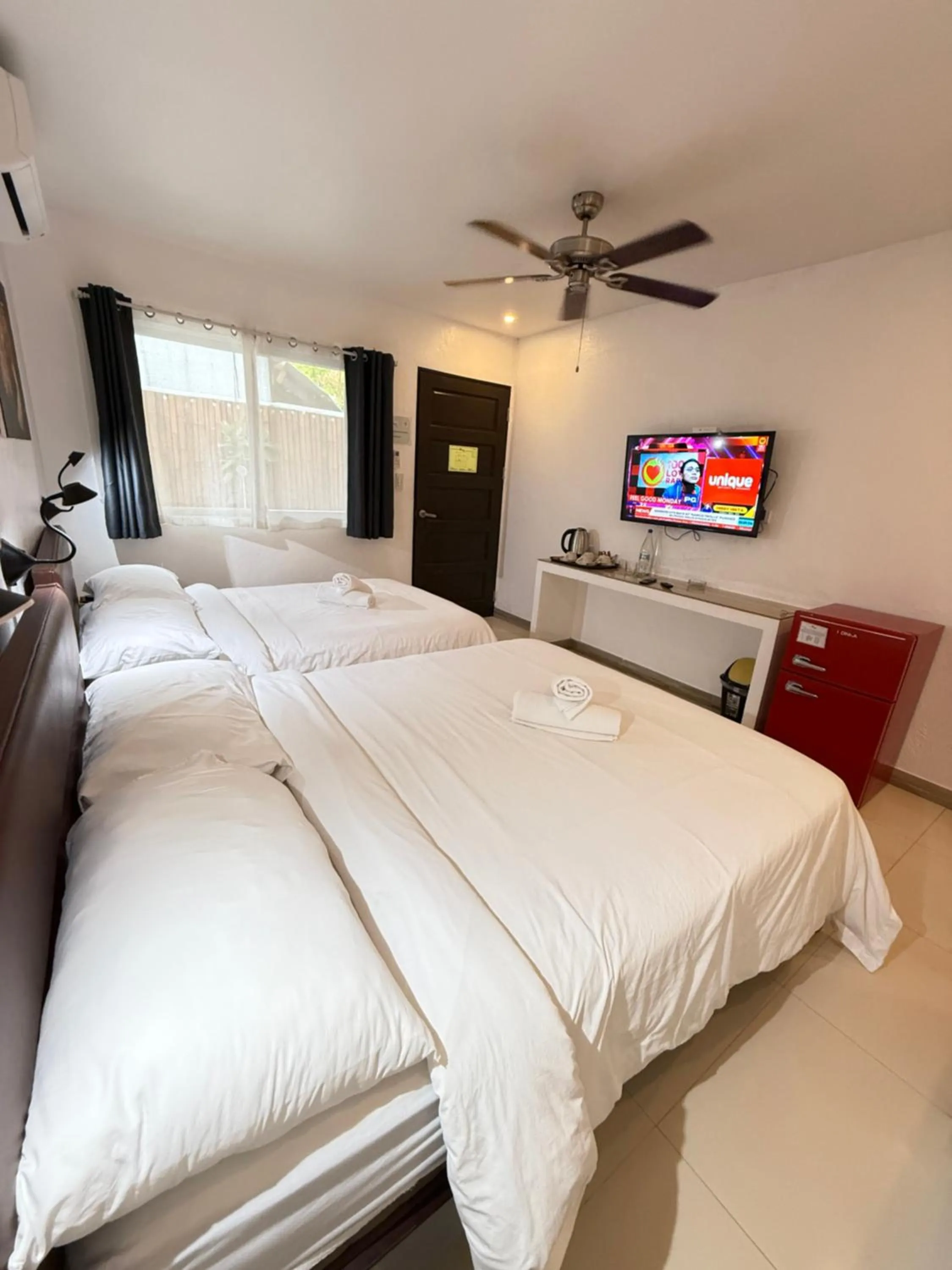Photo of the whole room, Bed in Calypso Beach and Dive Resort