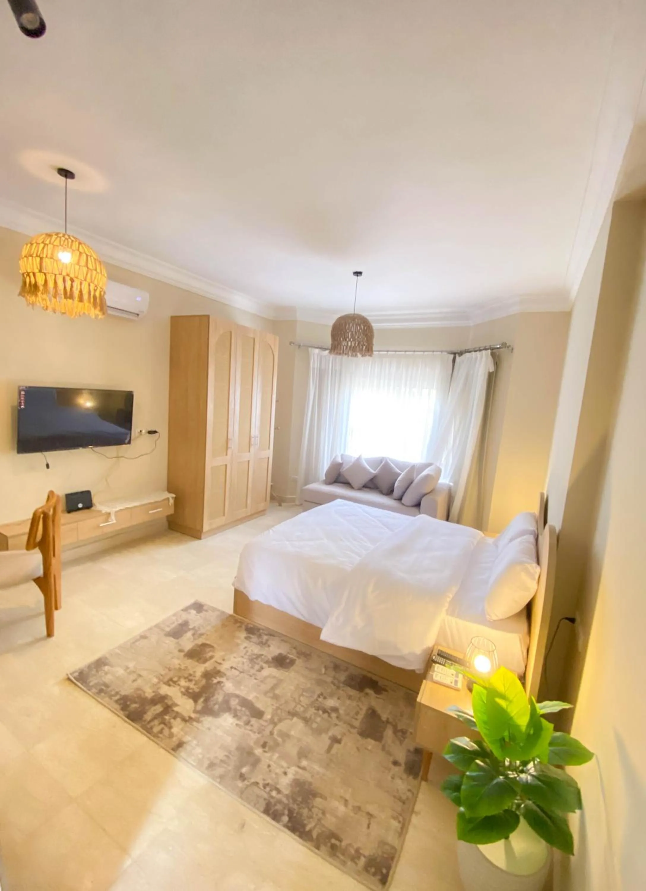 Seating area, Bed in Settle Inn Al Rehab City B