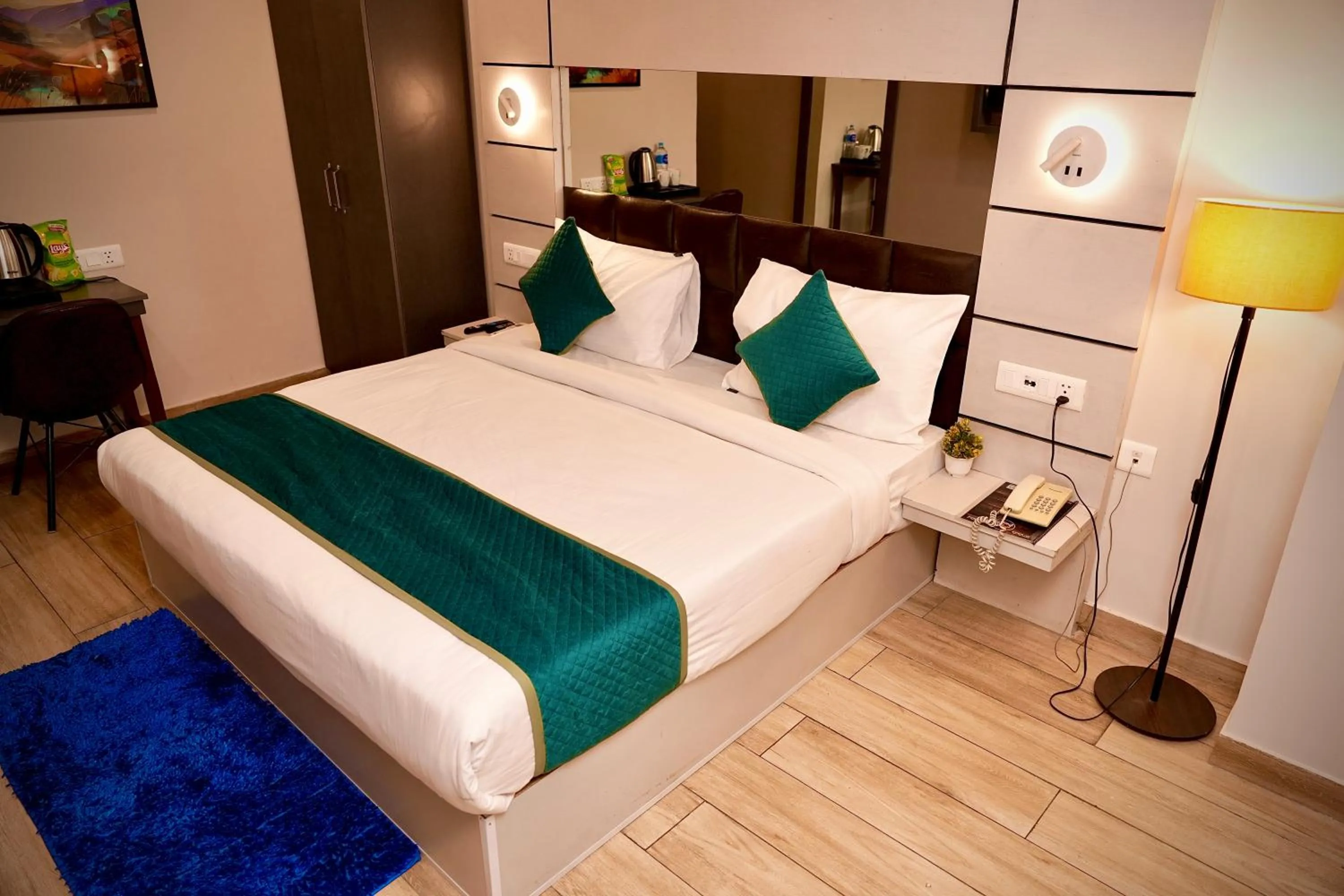 Bed in Hotel Royal Saffron by Majesta Stays