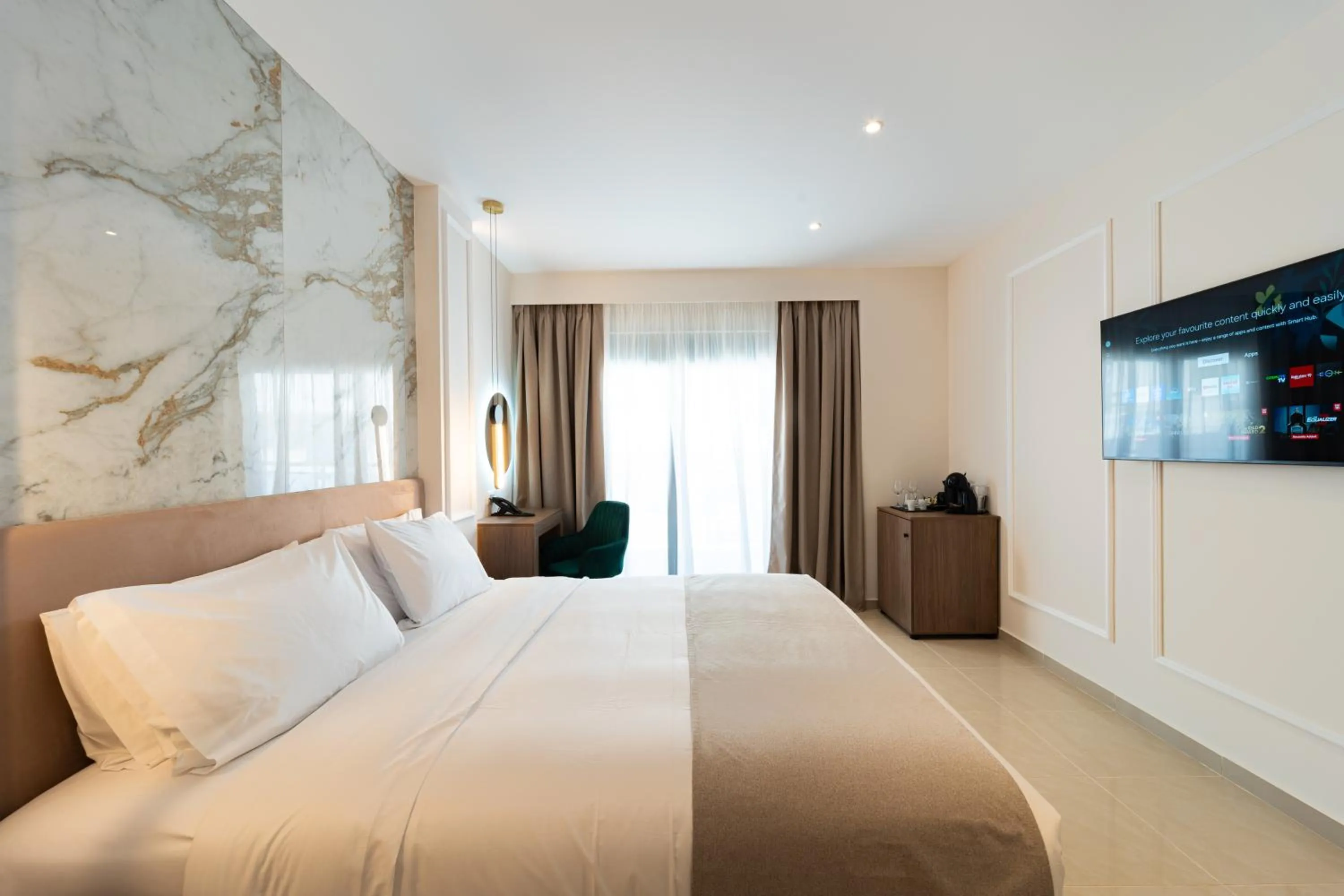 Bed in Philia Center Suites