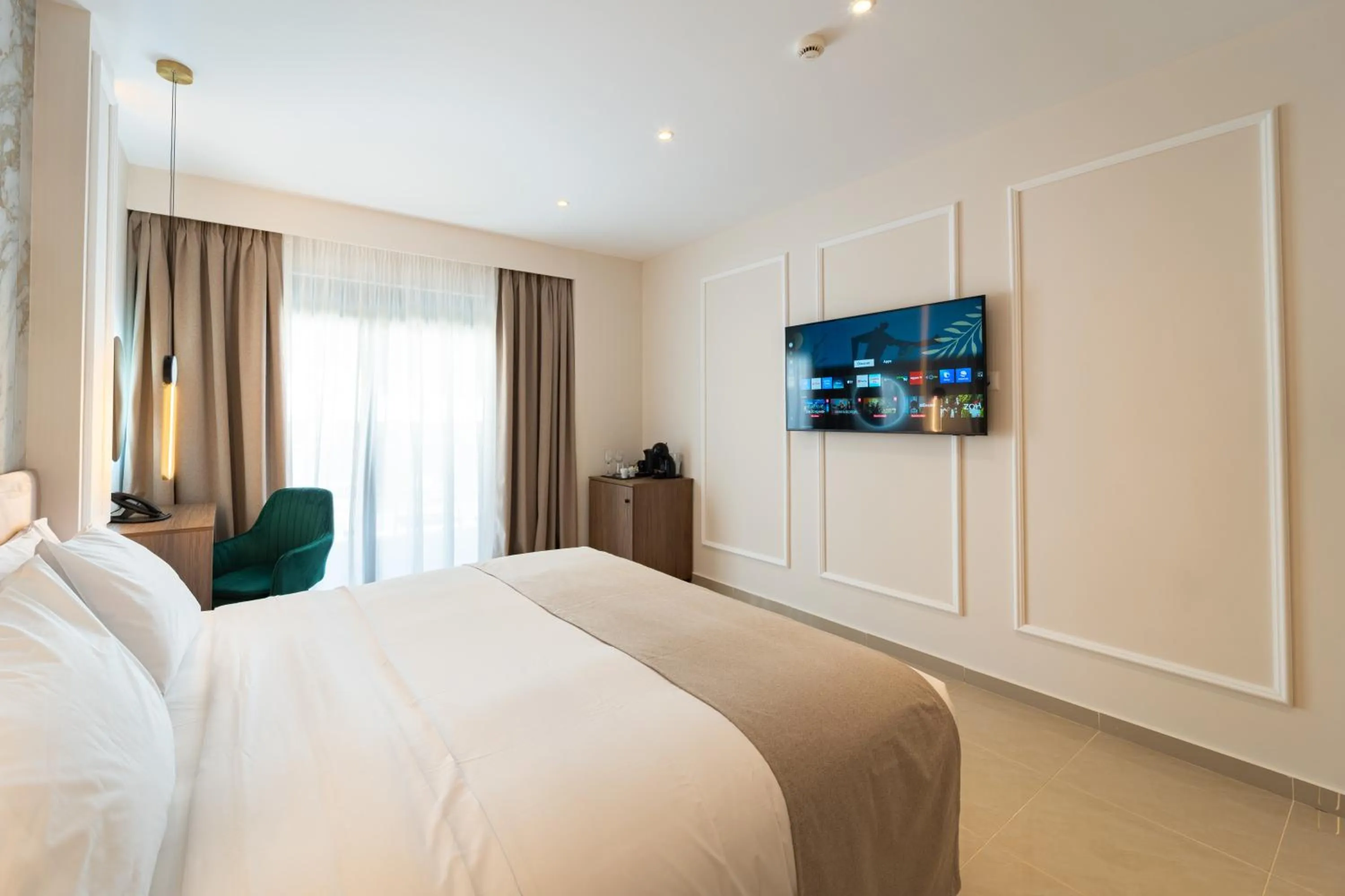 Bed in Philia Center Suites