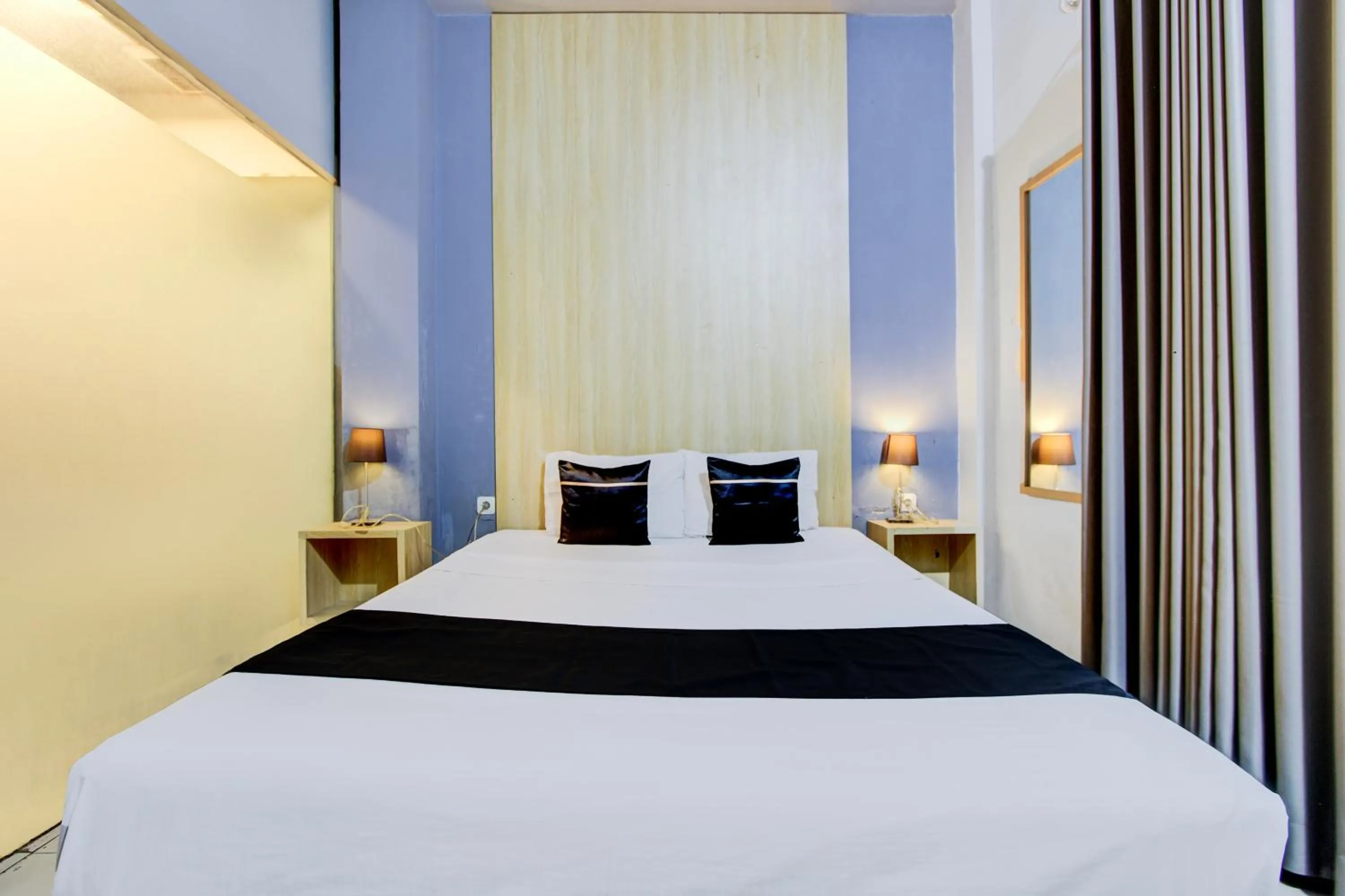 Photo of the whole room, Bed in Hotel O Tegal near near Pacific Mall Tegal formerly Hugo Suites Family