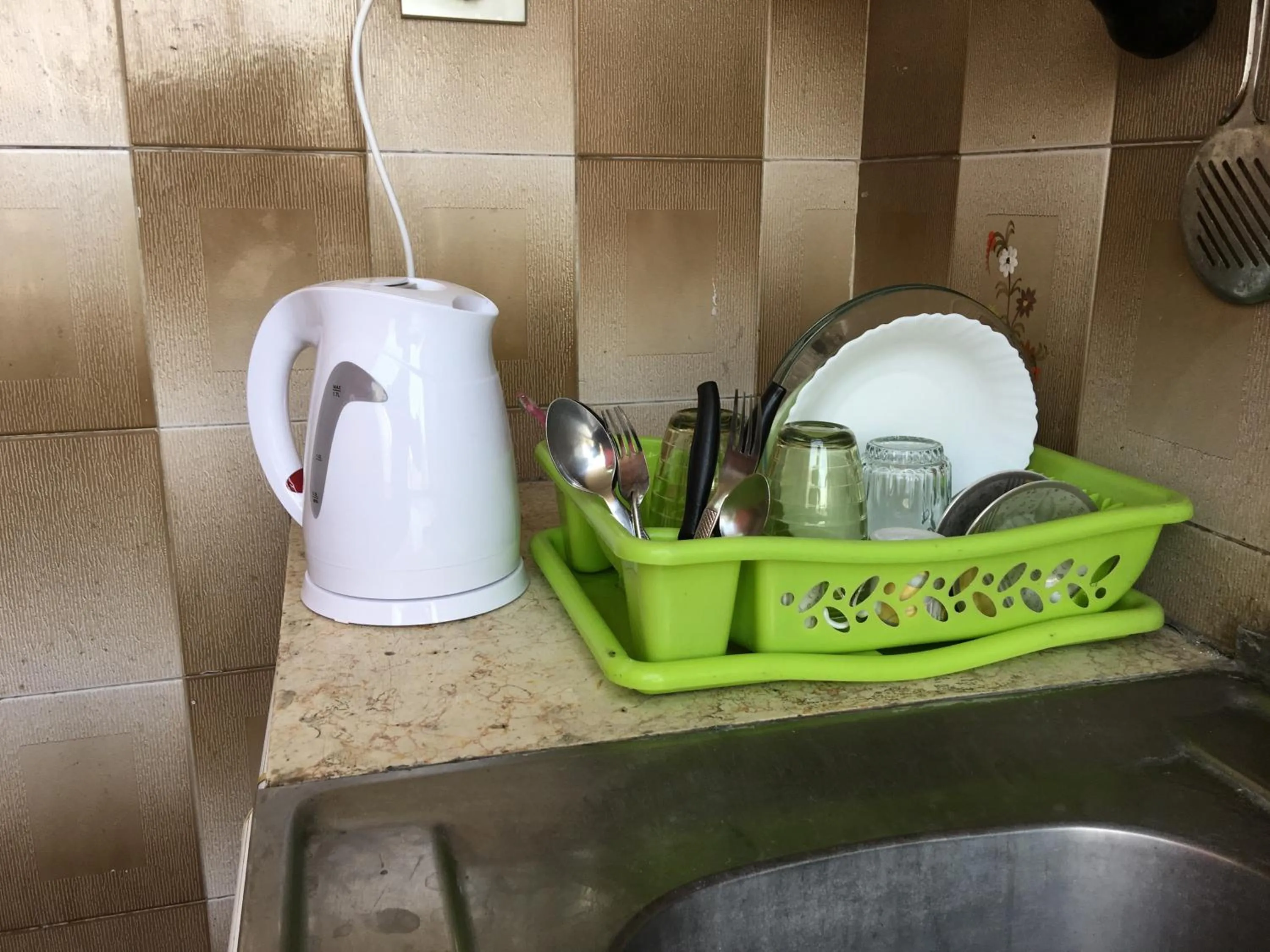 Kitchen or kitchenette in Aljazeera Hotel Apartments
