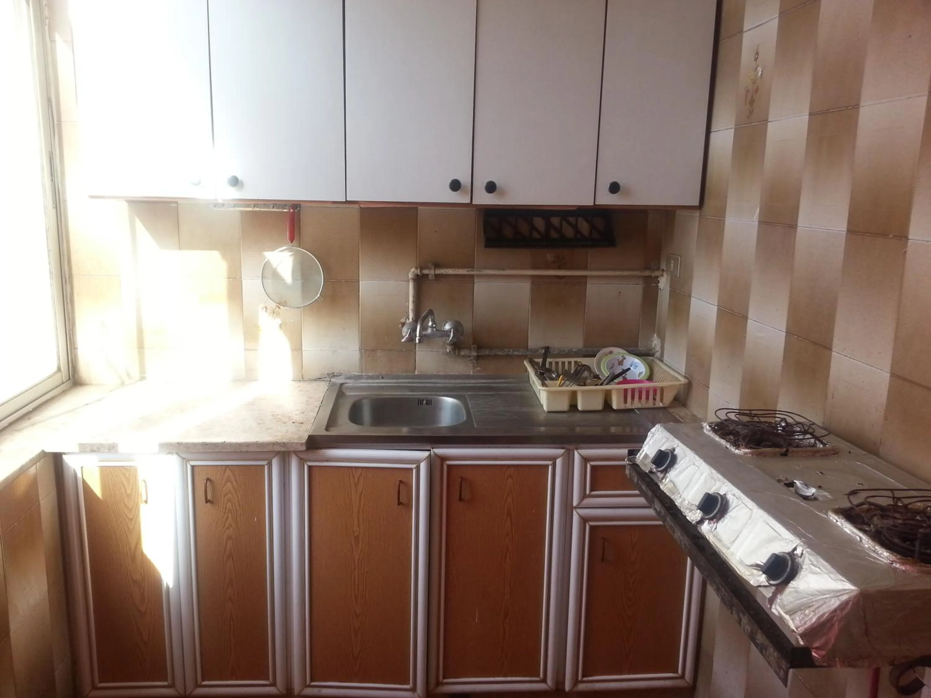 Kitchen or kitchenette in Aljazeera Hotel Apartments