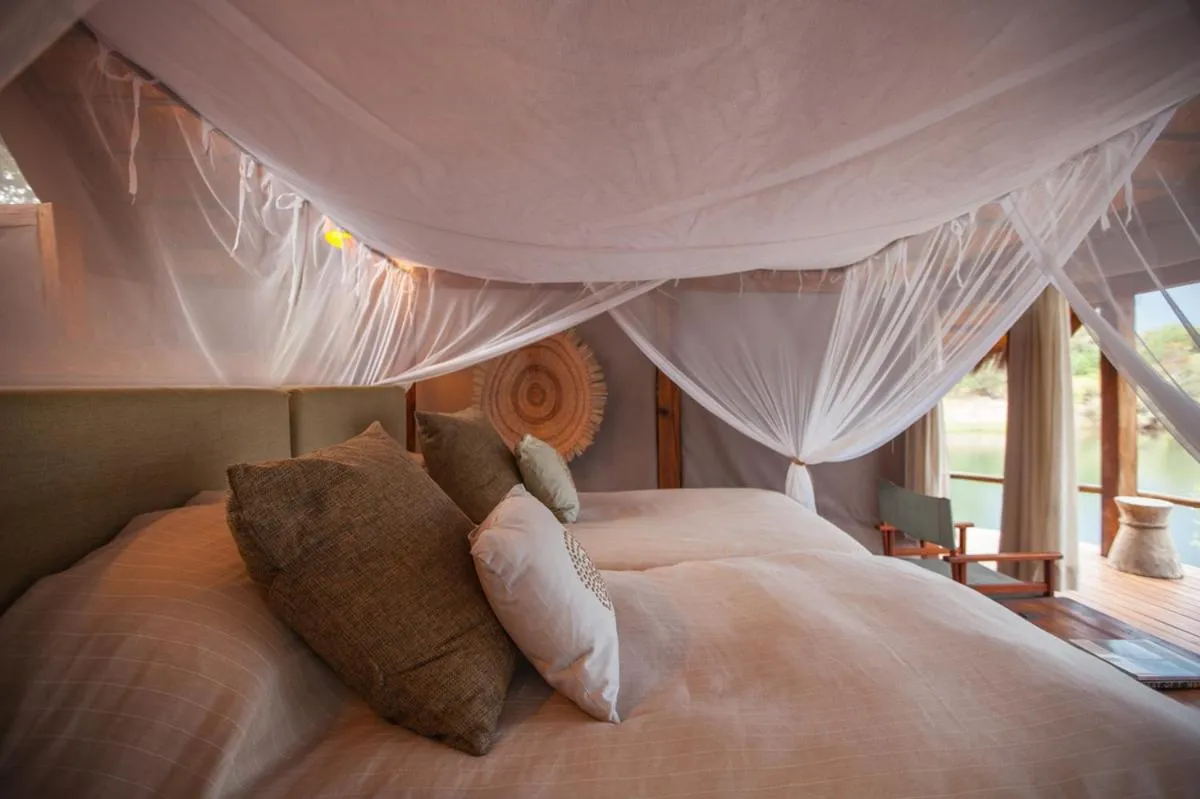 Bed in Sindabezi Island Camp