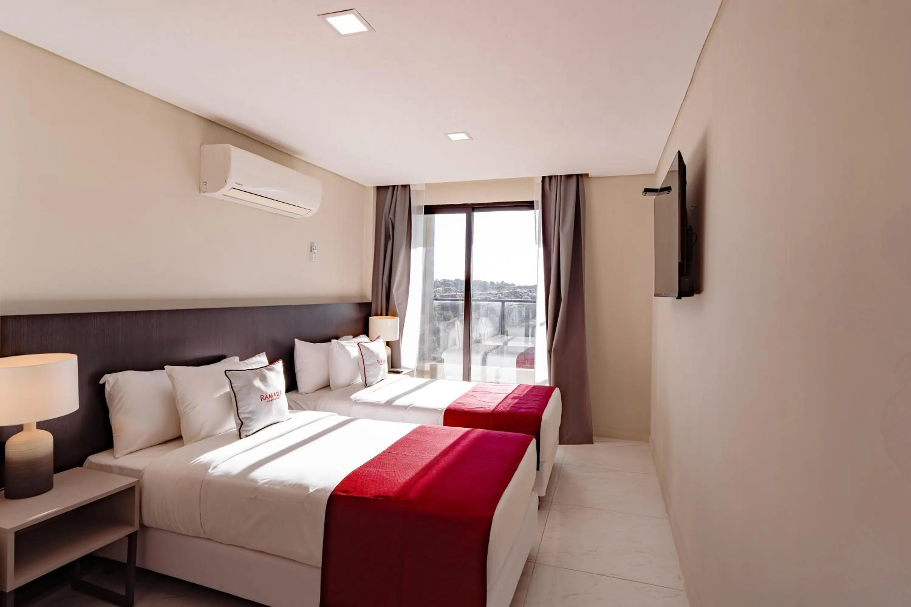 Bed in Ramada Suites by Wyndham Asuncion Aeropuerto