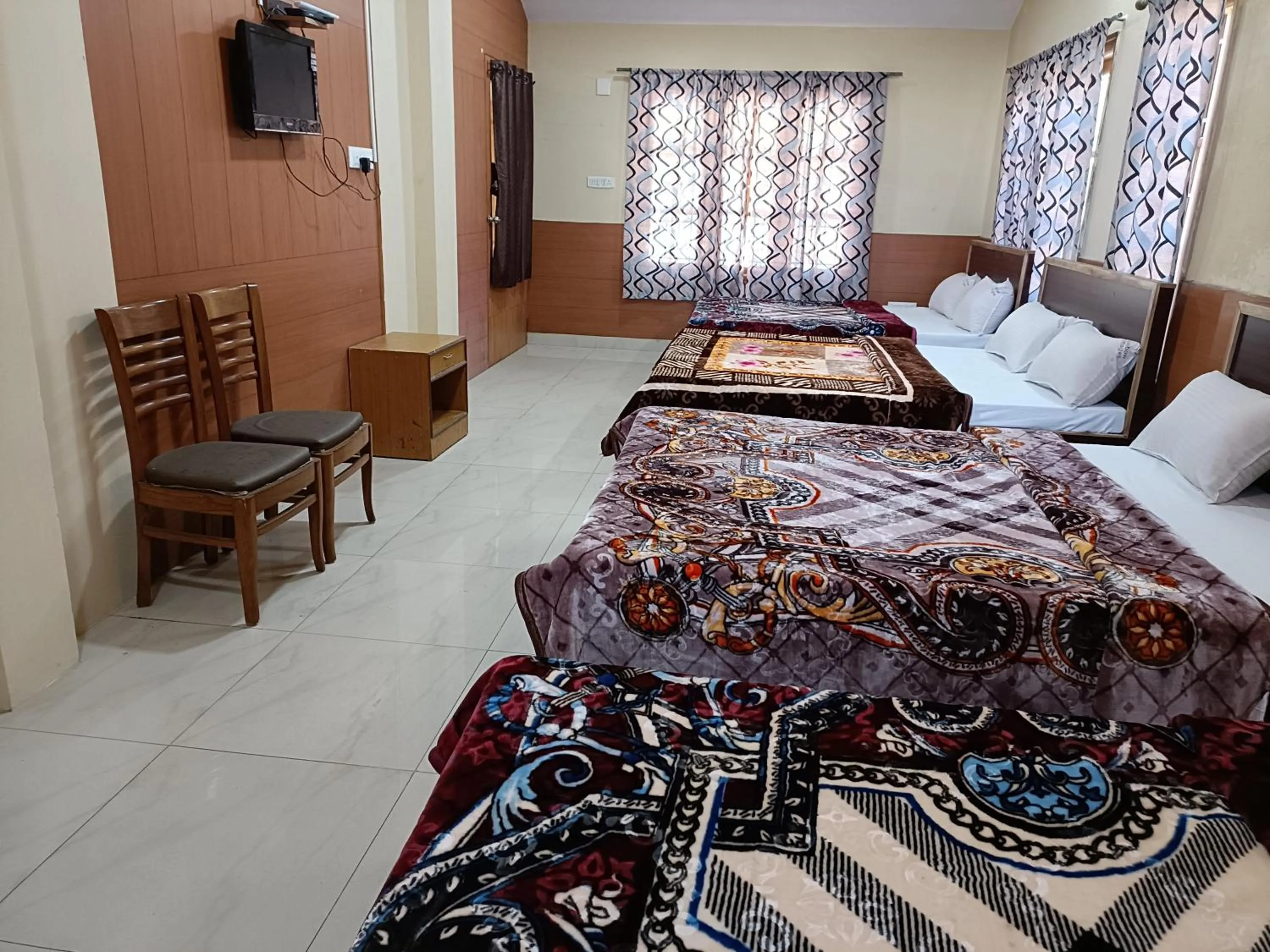 Seating area, Bed in Rainbow Cottages-Budget Friendly rooms