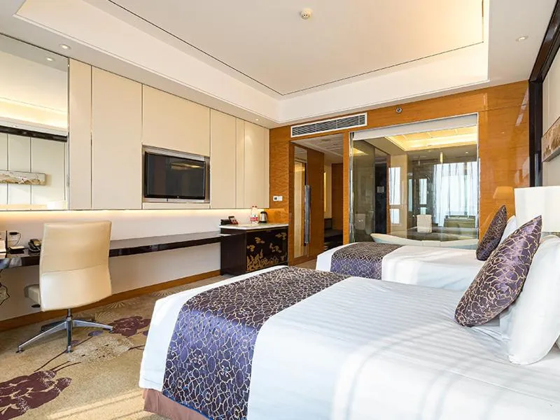 Bed in New Century Grand Hotel Siyang