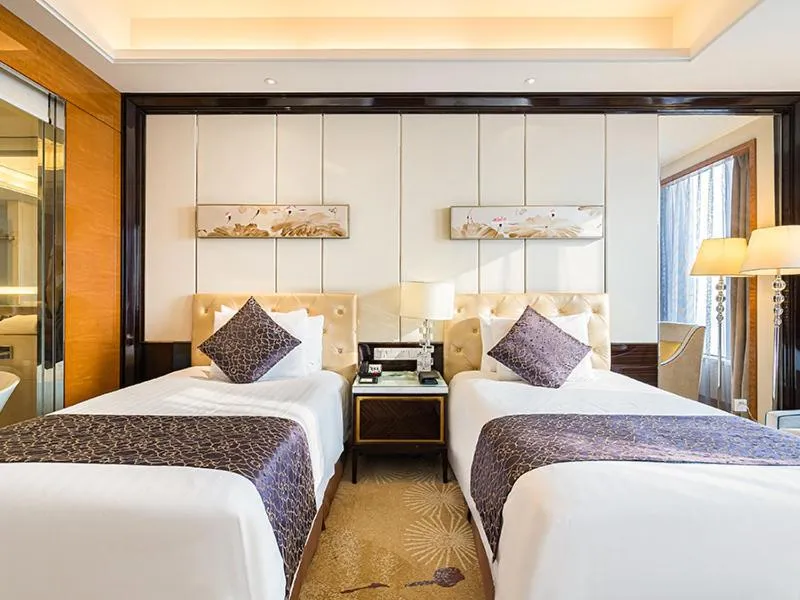 Bed in New Century Grand Hotel Siyang