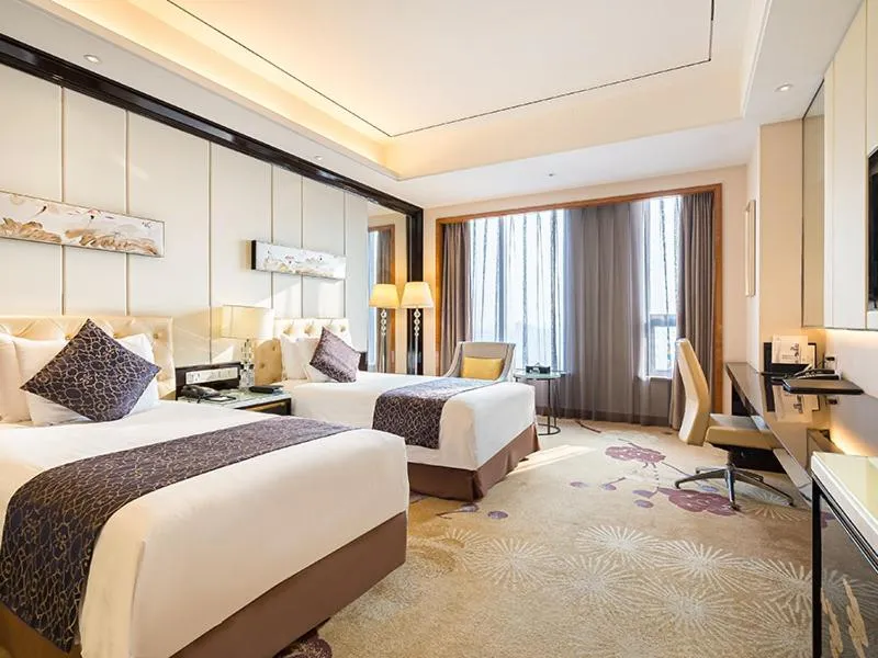 Bed in New Century Grand Hotel Siyang