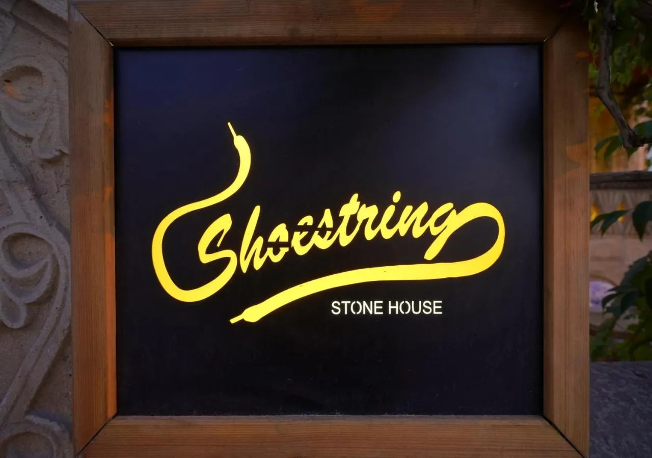 Property logo or sign in ShoeString Stone House