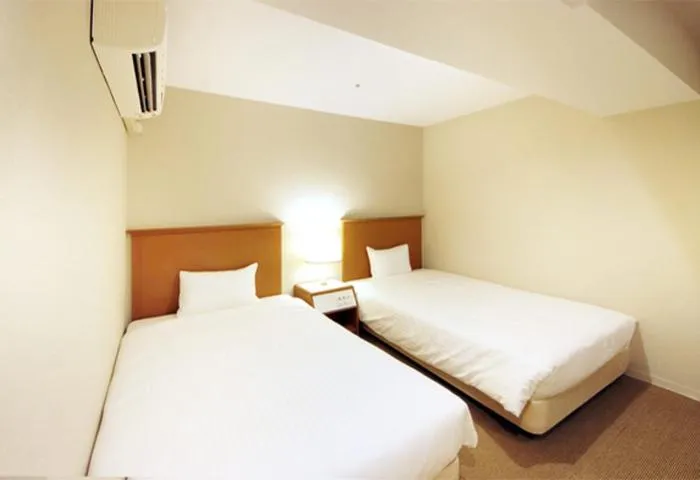 Bed in Quintessa Hotel Akita