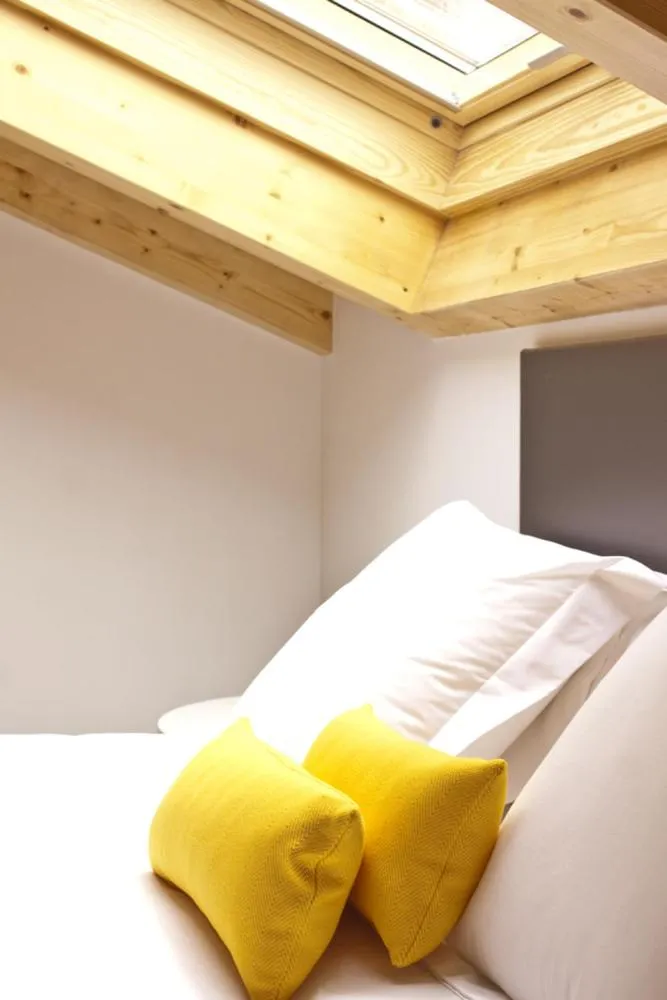 Decorative detail, Bed in Lux Apartamentos Santiago