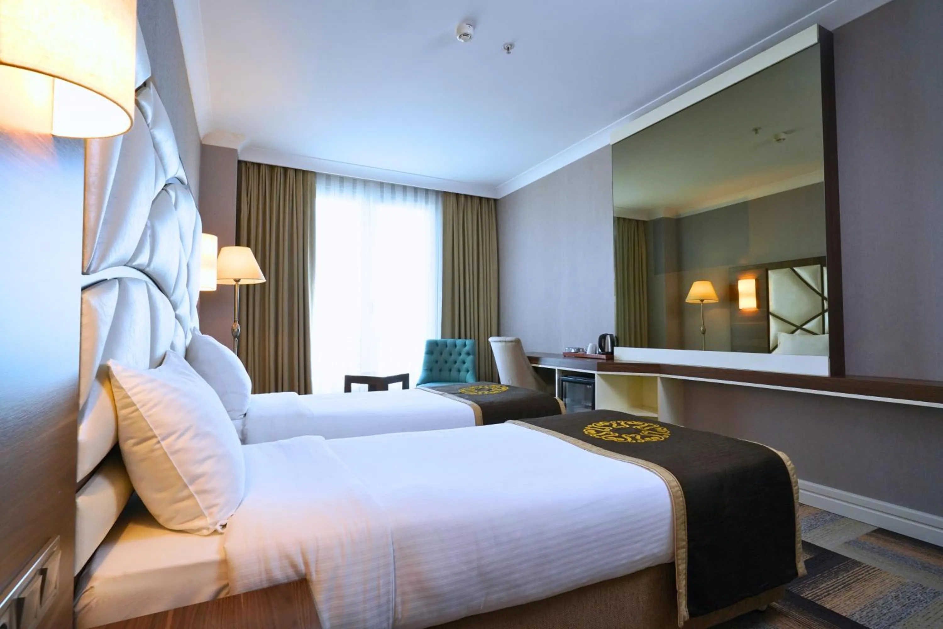 Bed in The Grand Mira Business Hotel