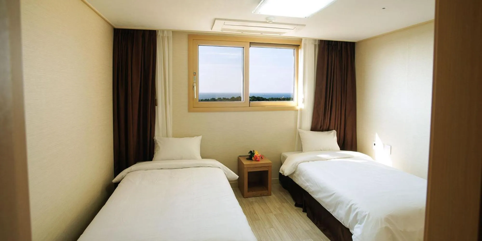 Bed in Hi Jeju Hotel