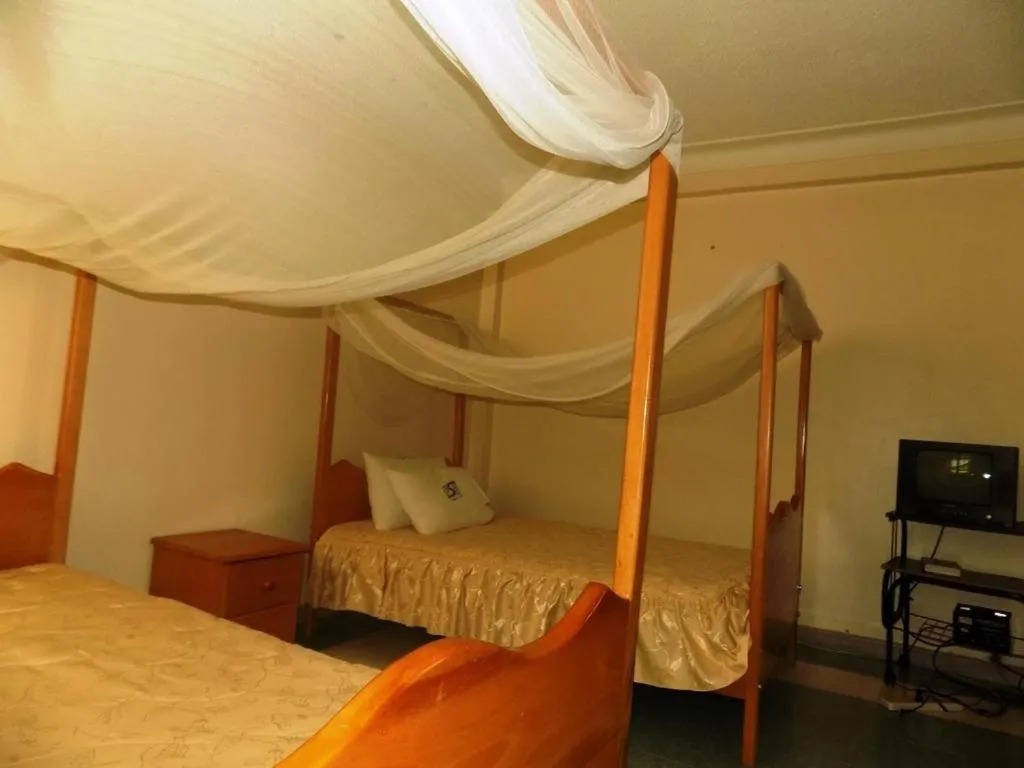 Bed in Palm Springs Hotel Masaka