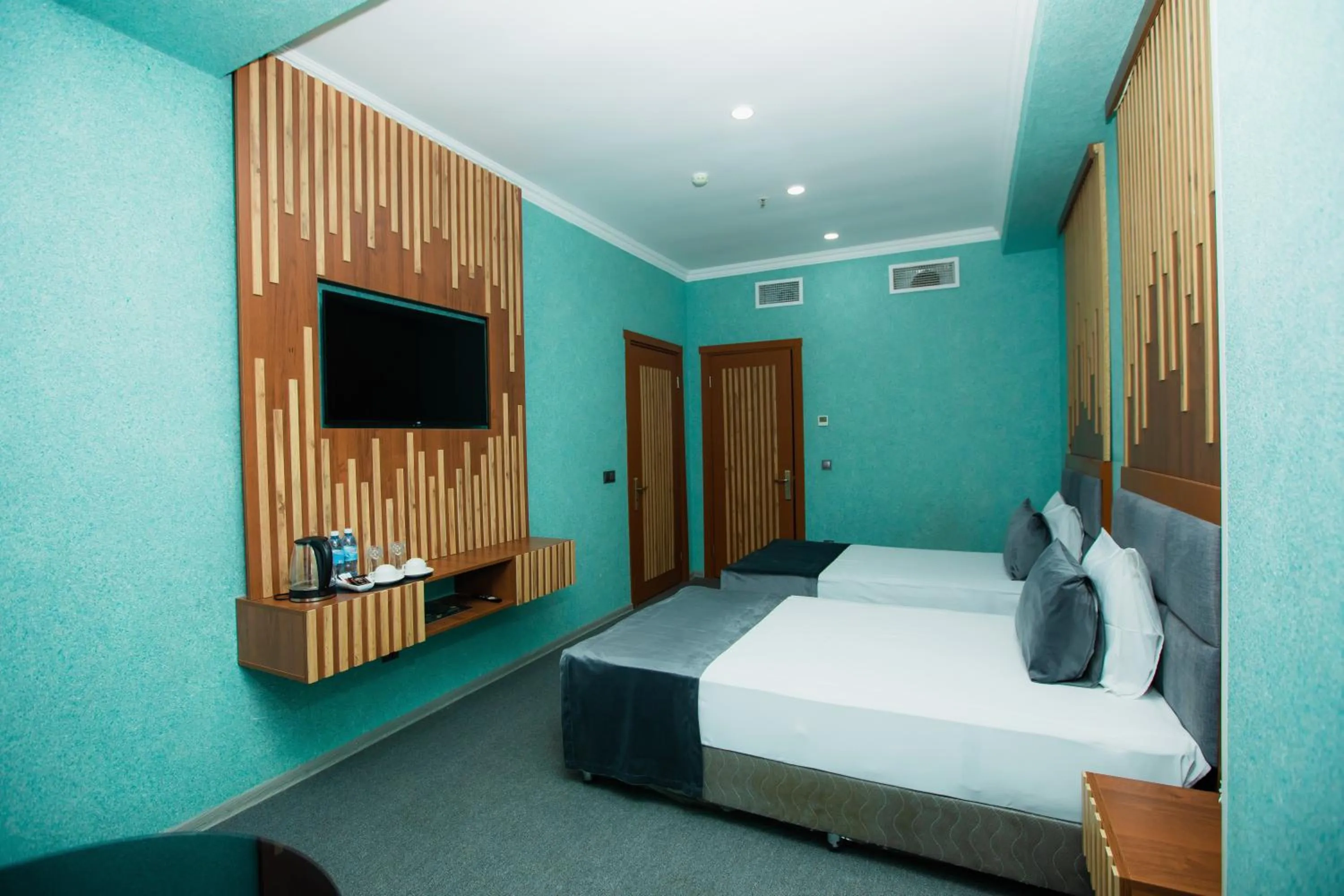 Communal lounge/ TV room, Bed in Corniche White City Hotel