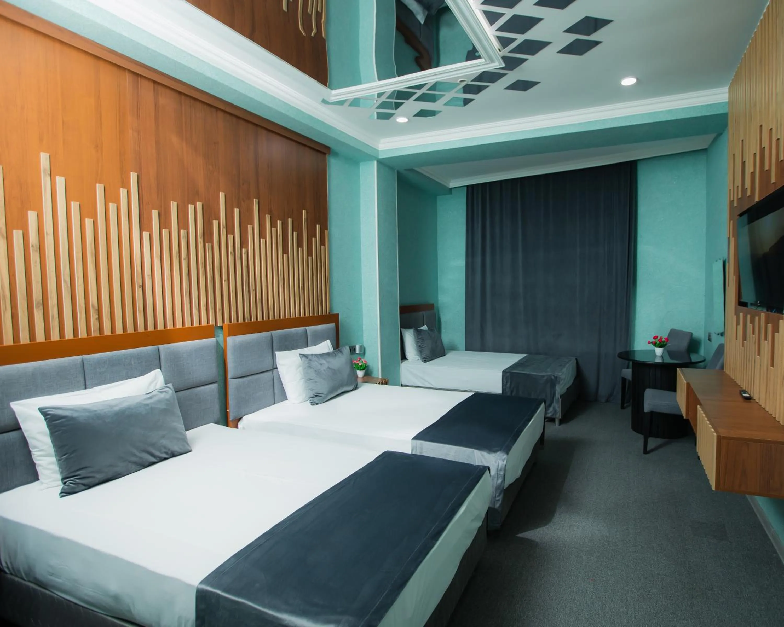 Communal lounge/ TV room, Bed in Corniche White City Hotel