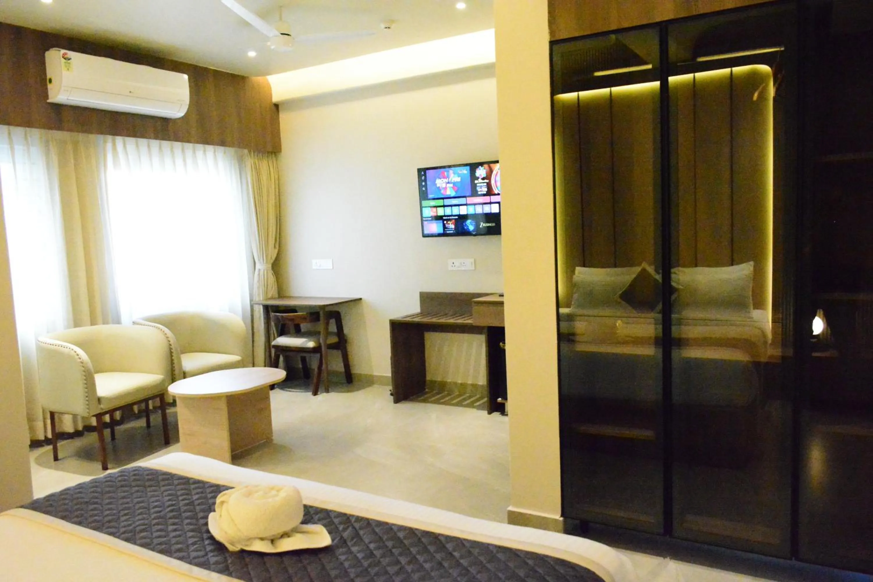 Communal lounge/ TV room, Bed in Hotel Muthahalli Grand